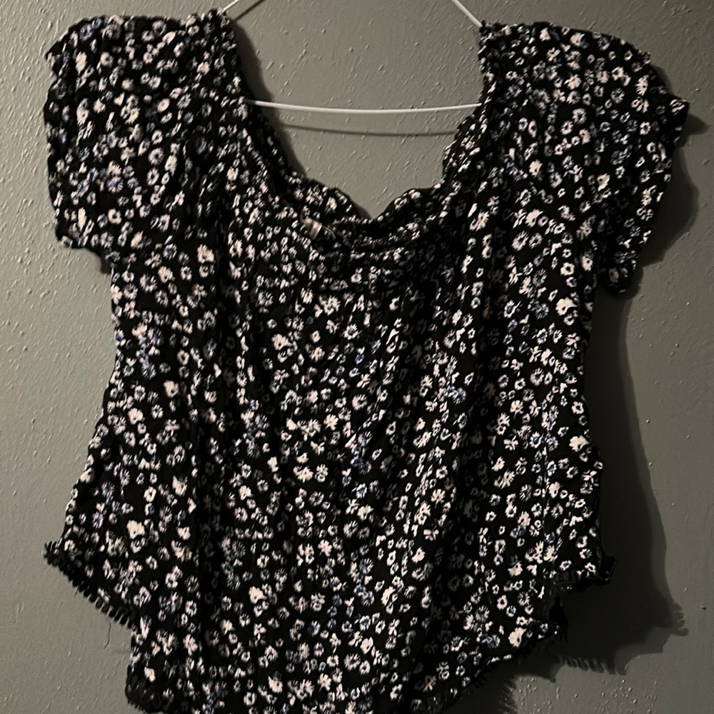 Black off the shoulder top with blue and white floral design